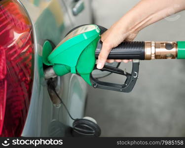 a Person Refueling the Car at a Gas Station