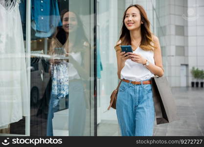A person walking in the city, lost in her smartphone screen. She is browsing the internet, connecting with the global cyber world around her.