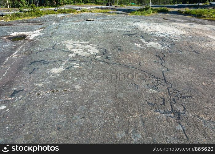 A petroglyphs are ancient drawings on a large stone, Karelia, Russia.