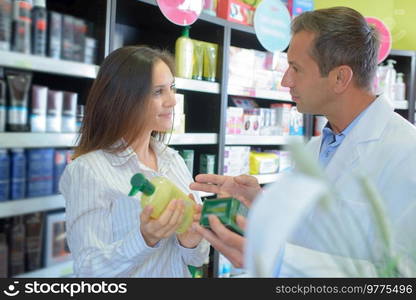 a pharmacist advising a customer