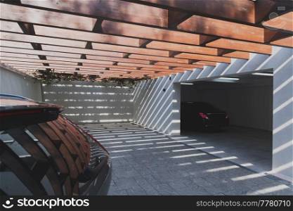 A photo of a suitcase standing next to a car in a luxury garage. High-quality photo. A photo of a suitcase standing next to a car in a luxury garage. Selective focus