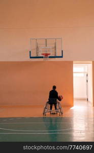 a photo of a war veteran playing basketball in a modern sports arena. The concept of sport for people with disabilities. High quality photo. a photo of a war veteran playing basketball in a modern sports arena. The concept of sport for people with disabilities