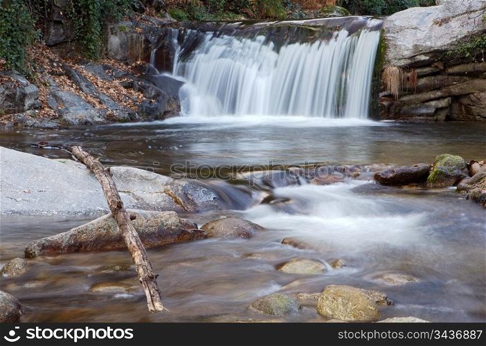 a photo of a water torrent in the forest