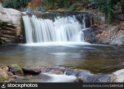 a photo of a water torrent in the forest