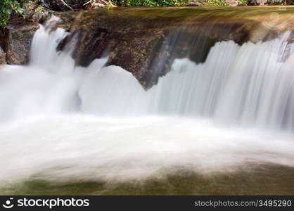 a photo of a water torrent in the forest