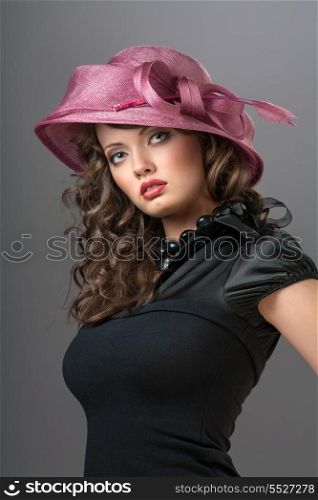A photo of enigmatic beauty in the pink hat with a bow.