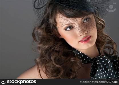 A photo of puzzled beauty in the web hat.