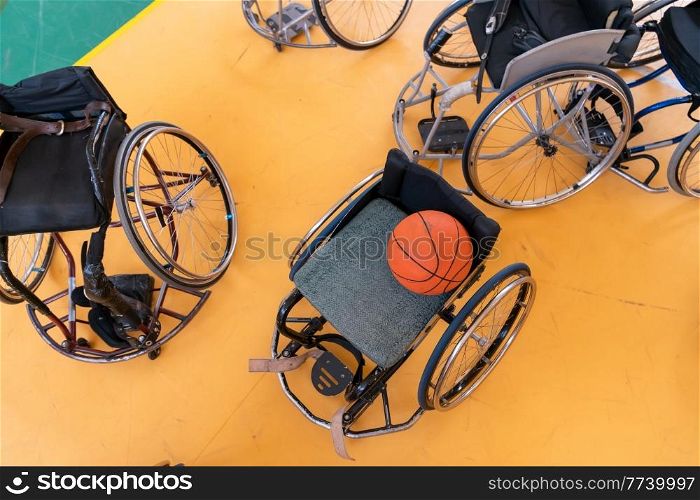 a photo of the wheelchair, wheelchair equipment, and ball located in the arena before the game. Selective focus . a photo of the wheelchair, wheelchair equipment and ball located in the arena before the game