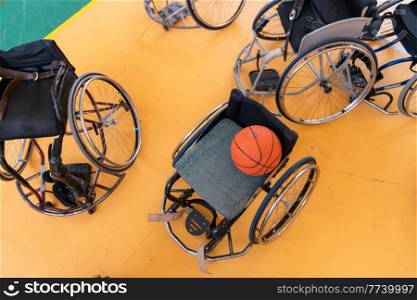 a photo of the wheelchair, wheelchair equipment, and ball located in the arena before the game. Selective focus . a photo of the wheelchair, wheelchair equipment and ball located in the arena before the game