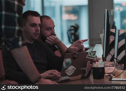 A photo of three men staring intently at a computer while sitting in a modern office. Selective focus. High-quality photo. A photo of three men staring intently at a computer while sitting in a modern office. Selective focus 