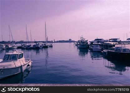a photograph of a ship and a luxury yacht anchored in the port. Beautiful photo of a Mediterranean port. High-quality photo. A photograph of a ship and a luxury yacht anchored in port. Beautiful photo of a Mediterranean port
