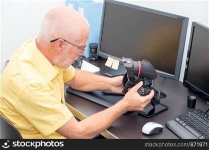 a photographer and camera at office with computer