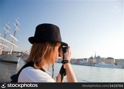 A photographer artist taking pictures of waterfront of Stockholm, Sweden