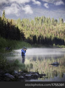 A photographer lines up his shot on a beautiful sunny morning in Jasper National Park.