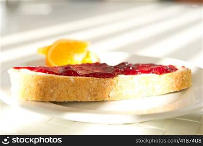 A pice of bread with jam in the morning
