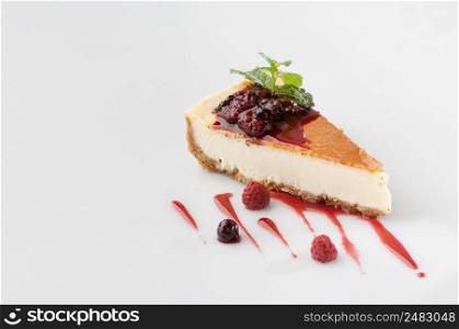 a piece of cake poured with sweet sauce over white background. cake on a white background
