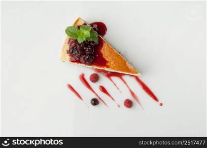 a piece of cake poured with sweet sauce over white background. cake on a white background