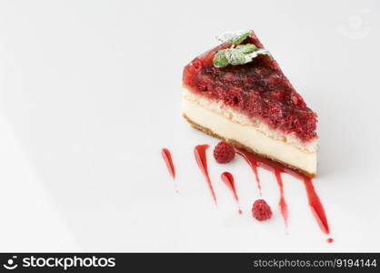 a piece of cake poured with sweet sauce over white background. cake on a white background