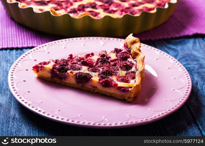 A piece of cheesecake with raspberries on a plate. Cheesecake with raspberries