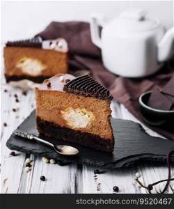 A piece of chocolate cake with tea