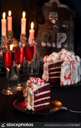 A piece of creepy cake (red velvet), decorated with meringue bones and drenched in blood. Great idea than treating guests.