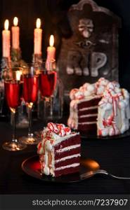 A piece of creepy cake (red velvet), decorated with meringue bones and drenched in blood. Great idea than treating guests.