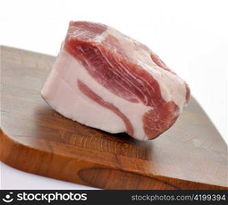 a piece of fresh salty pork on a cutting board