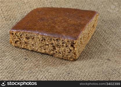 a piece of gingerbread cake on burlap canvas