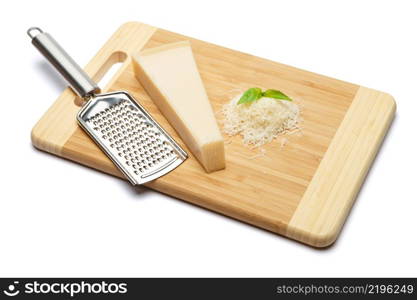 a piece of italian Parmesan and grated cheese on cutting board white background. a piece of Parmesan and grated cheese on cutting board white background