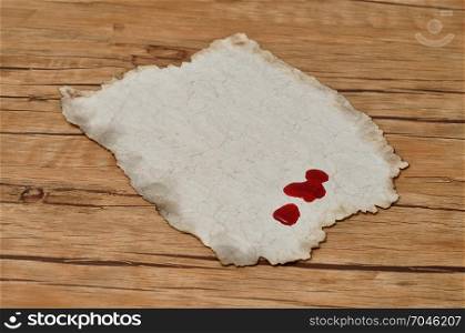 A piece of old paper with drops of blood