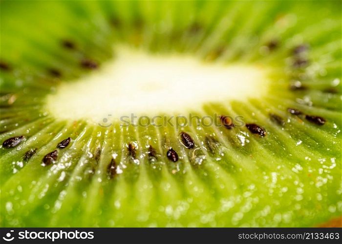 A piece of ripe kiwi. Macro background. Kiwi texture. High quality photo. A piece of ripe kiwi. Macro background.