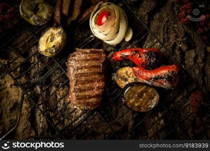 a piece of roasted meat with vegetables on the grill on a background of tree bark. dish on a tree bark
