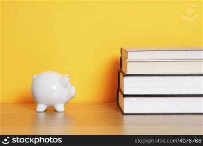 A piggy bank and a stack of books, can be used for &acute;saving for college&acute; design