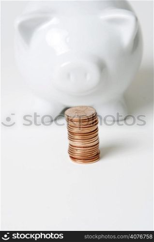 A piggy bank and a stack of coins