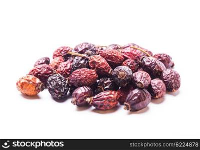 A pile berries of dried rosehips isolated on white. Dried dog-rose berries isolated
