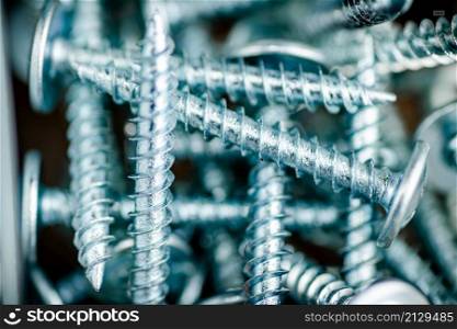 A pile of bolts. Macro background. High quality photo. A pile of bolts. Macro background.