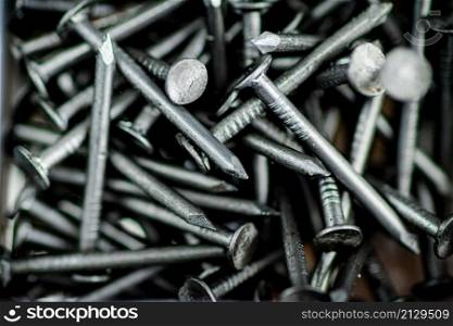 A pile of bolts. Macro background. High quality photo. A pile of bolts. Macro background.