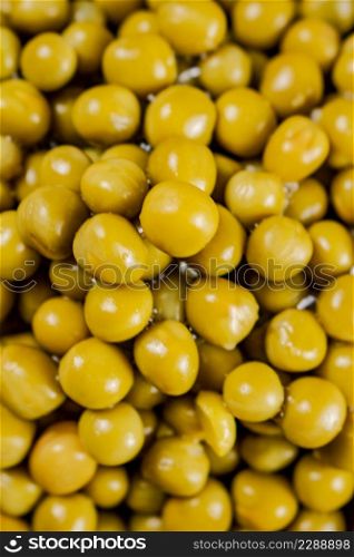 A pile of canned green peas. Macro background. Pea texture. High quality photo. A pile of canned green peas.