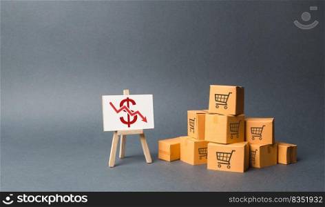 A pile of cardboard boxes and stand with a red down arrow. decline in the production of goods and products, the economic downturn and recession. Falling consumer demand, Falling prices, lower profits