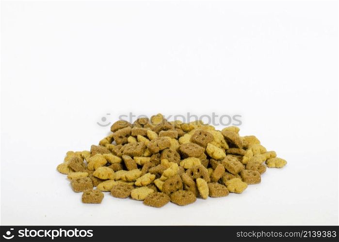 a pile of cat food grains, piled up on a white background