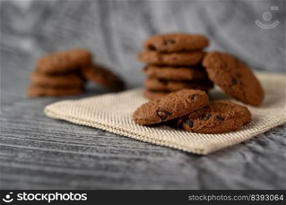 A pile of cookies on a cloth on a wooden table