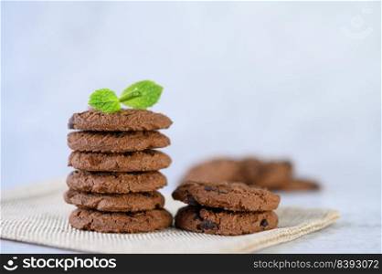 A pile of cookies on a cloth on a wooden table