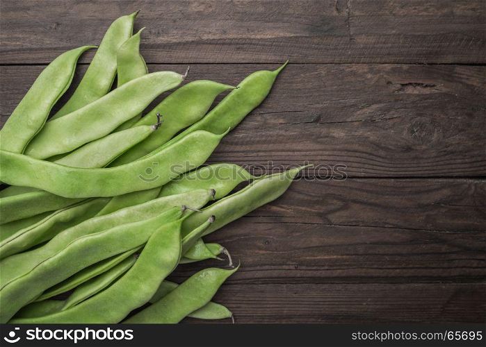 A pile of fresh green beans on table. Green runner beans. Top view