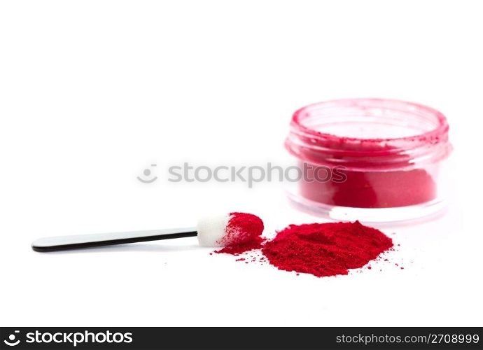 A pile of loose red powder with eyeshadow brush. Shot on white background.
