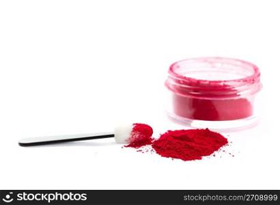 A pile of loose red powder with eyeshadow brush. Shot on white background.