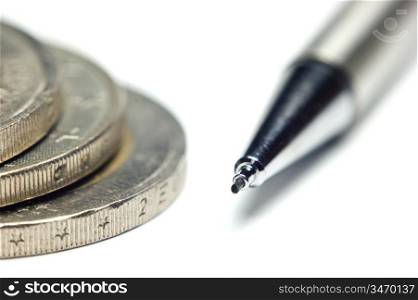 a pile of metal coins and pencil