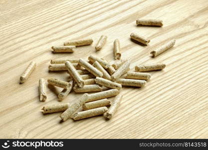 A pile of pellets placed on a top of the same wood