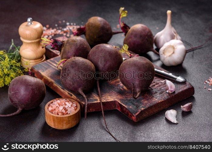 A pile of raw beets on the table. The benefits of vegetables. Harvest and natural products. A pile of raw beets on the table. The benefits of vegetables