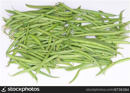 A pile of raw string beans, isolated on white