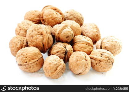 A pile of raw walnuts on a white background